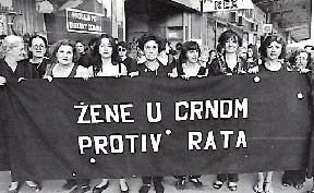 Women in Black holding a vigil (and a banner) in Serbia