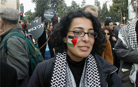 Smiling young woman with Palestinian flag painted on her cheek