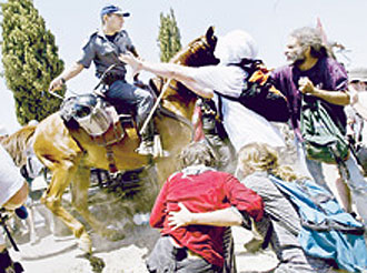 Demonstrators cling to each other as a soldier on horseback rides through